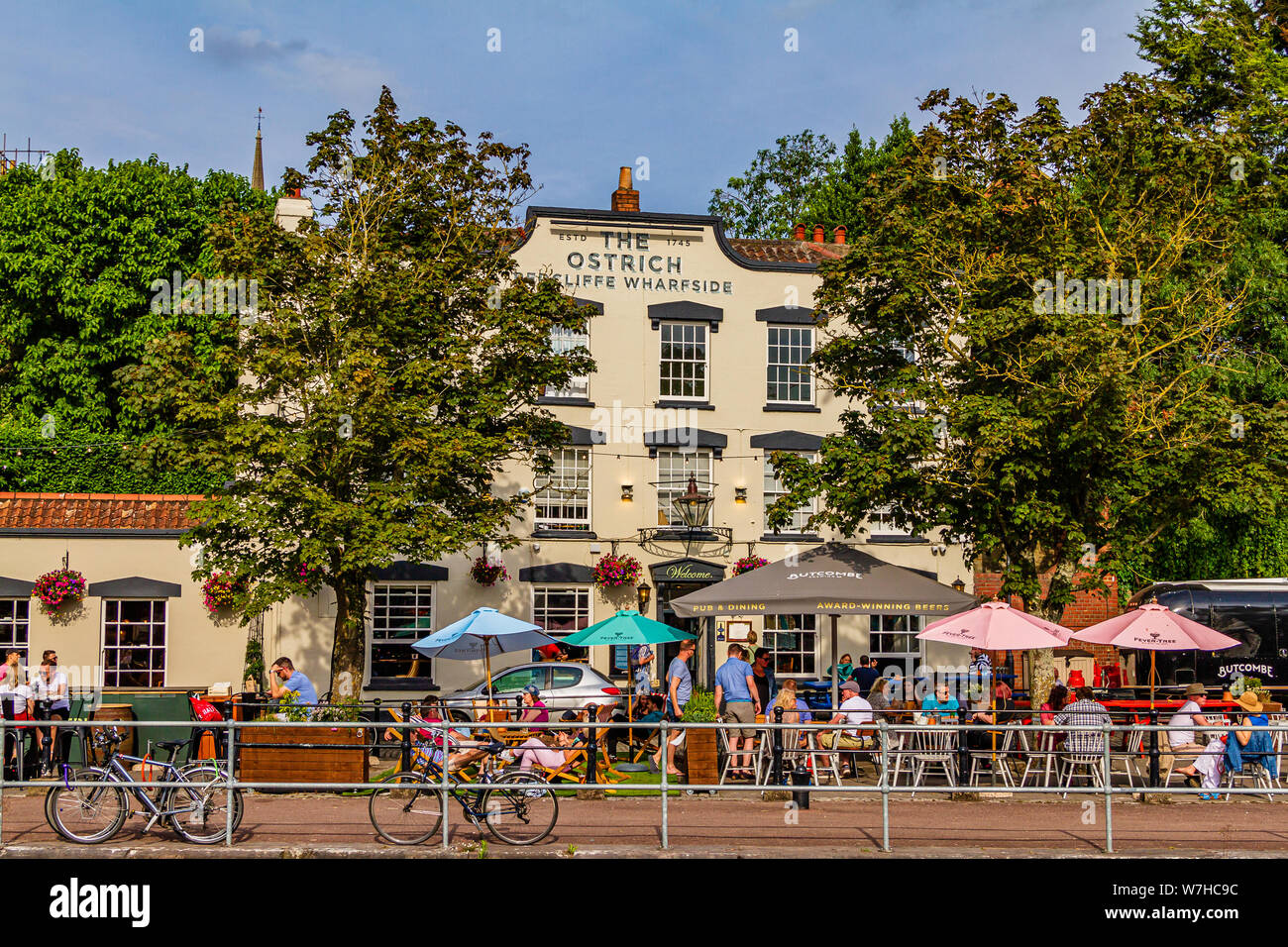 The Ostrich, a historic harbourside pub now run by Butcombe Brewery, on a sunny summer day with people enjoying the garden. Bristol, UK. July 2019. Stock Photo