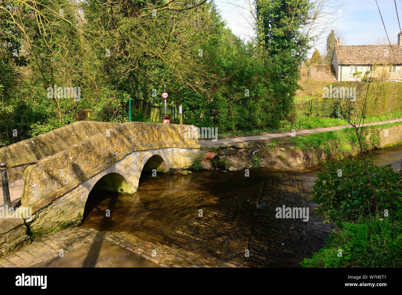 Dummers packhorse bridge and Bide Brook ford in Lacock, Wiltshire. Stock Photo