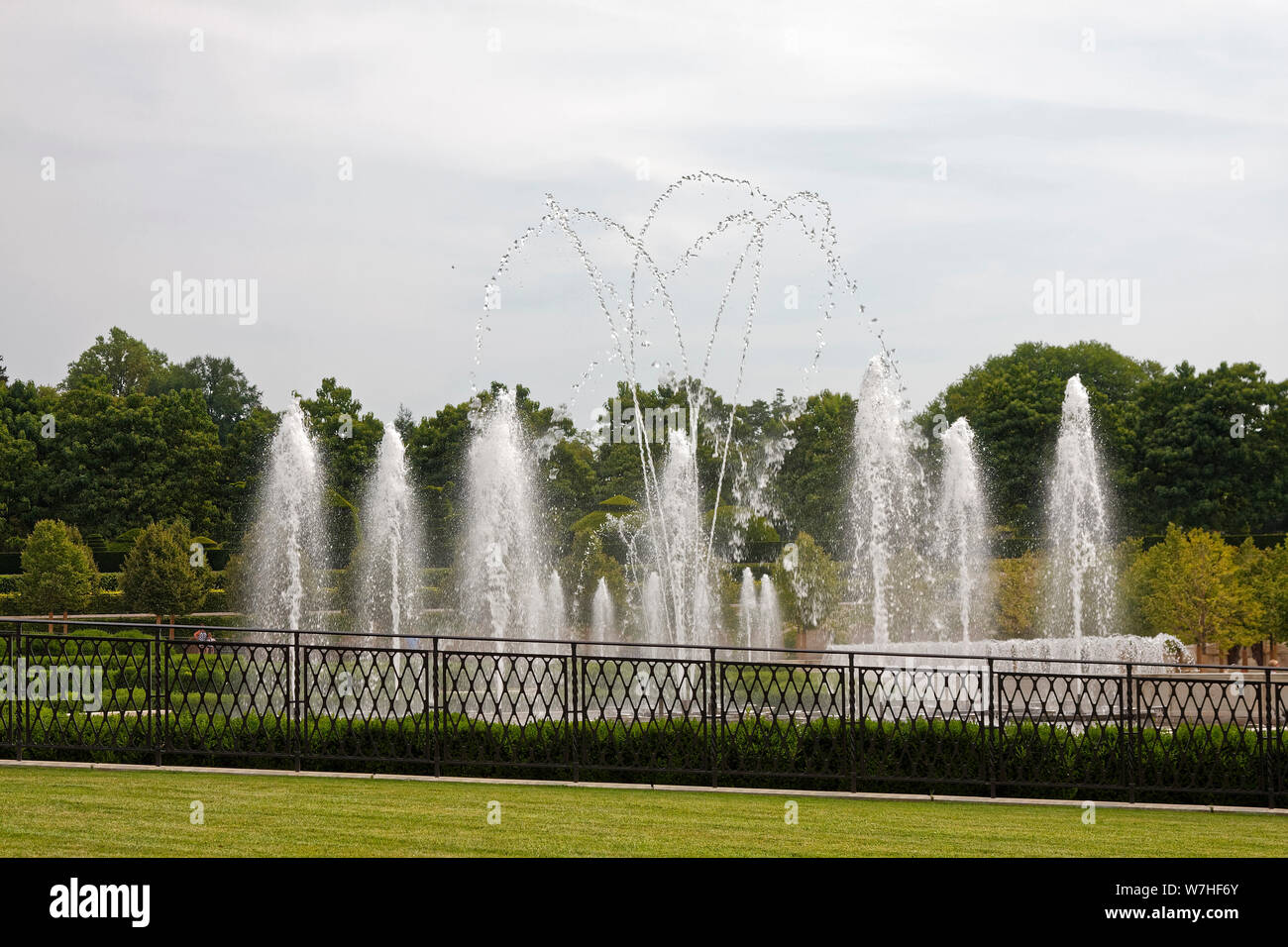 Main Fountain Garden; dancing water, trees, grass, metal fence