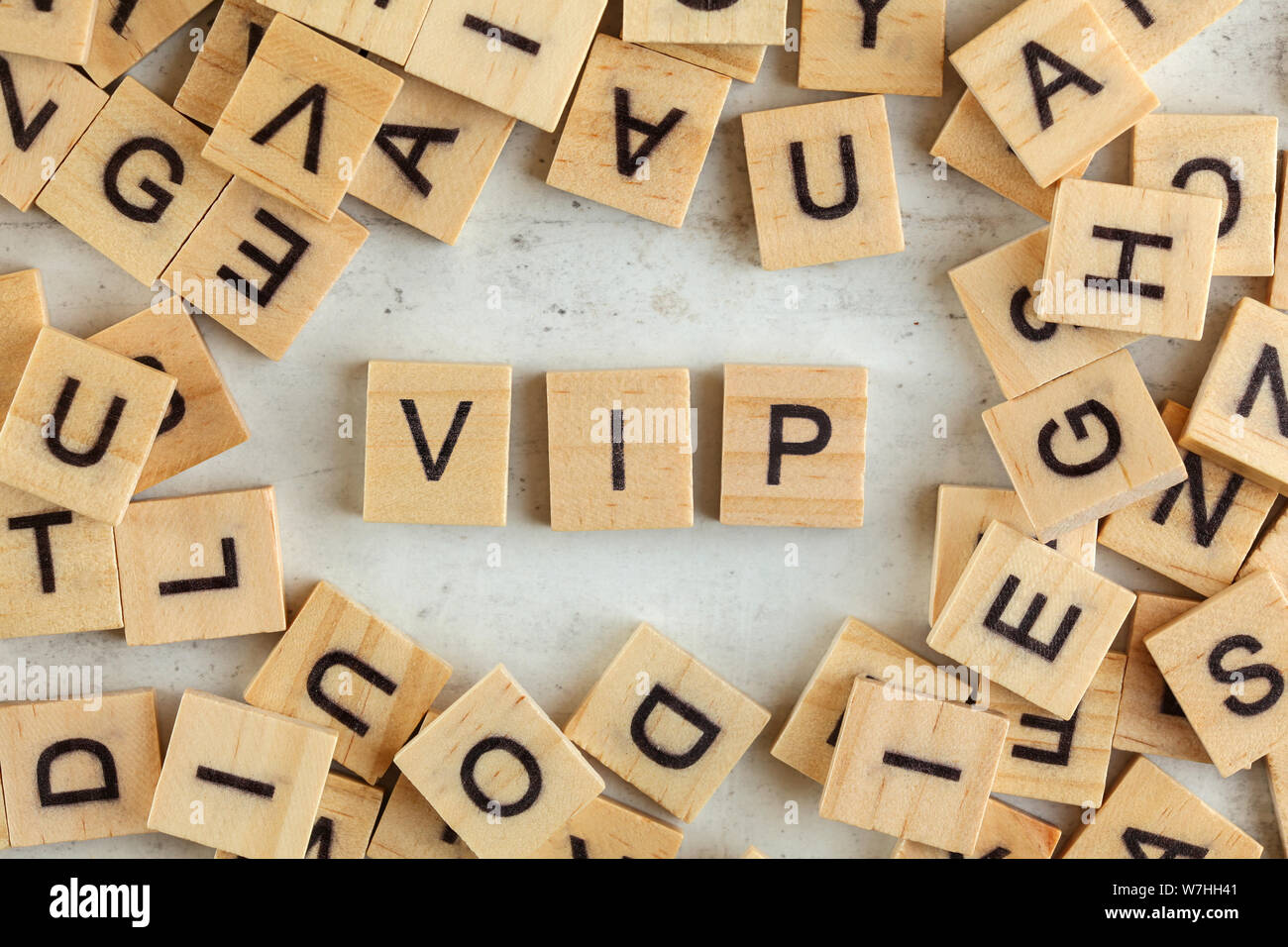 Top down view, pile of square wooden blocks with letters VIP (stands for Very important person