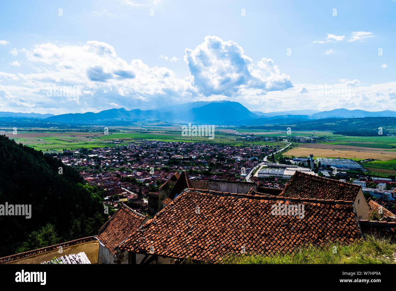 Landscape photo taken from the Rasnov Citadel showing the Rasnov city and the mountains in the distance - Rasnov, Brasov country, Transylvania, Romani Stock Photo