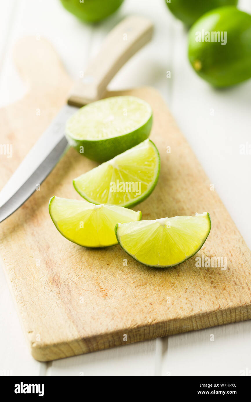 The green sliced lime on cutting board. Stock Photo