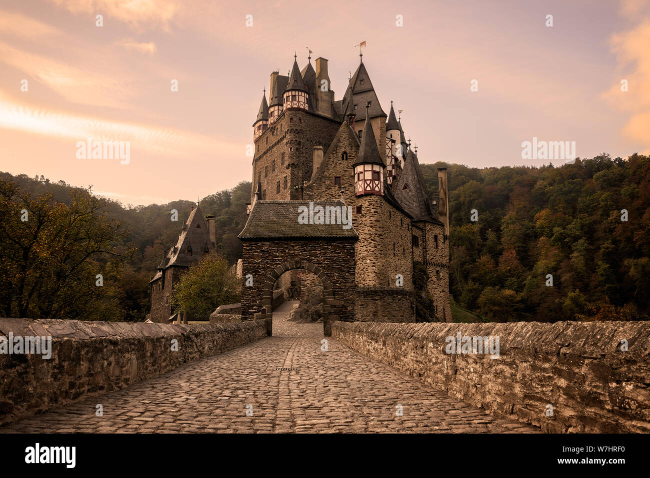 Cobblestone street with arch towards the medieval Burg Eltz Castle at sunrise near Mosel river in Wierschem, Rhineland-Palatinate, Germany. Stock Photo