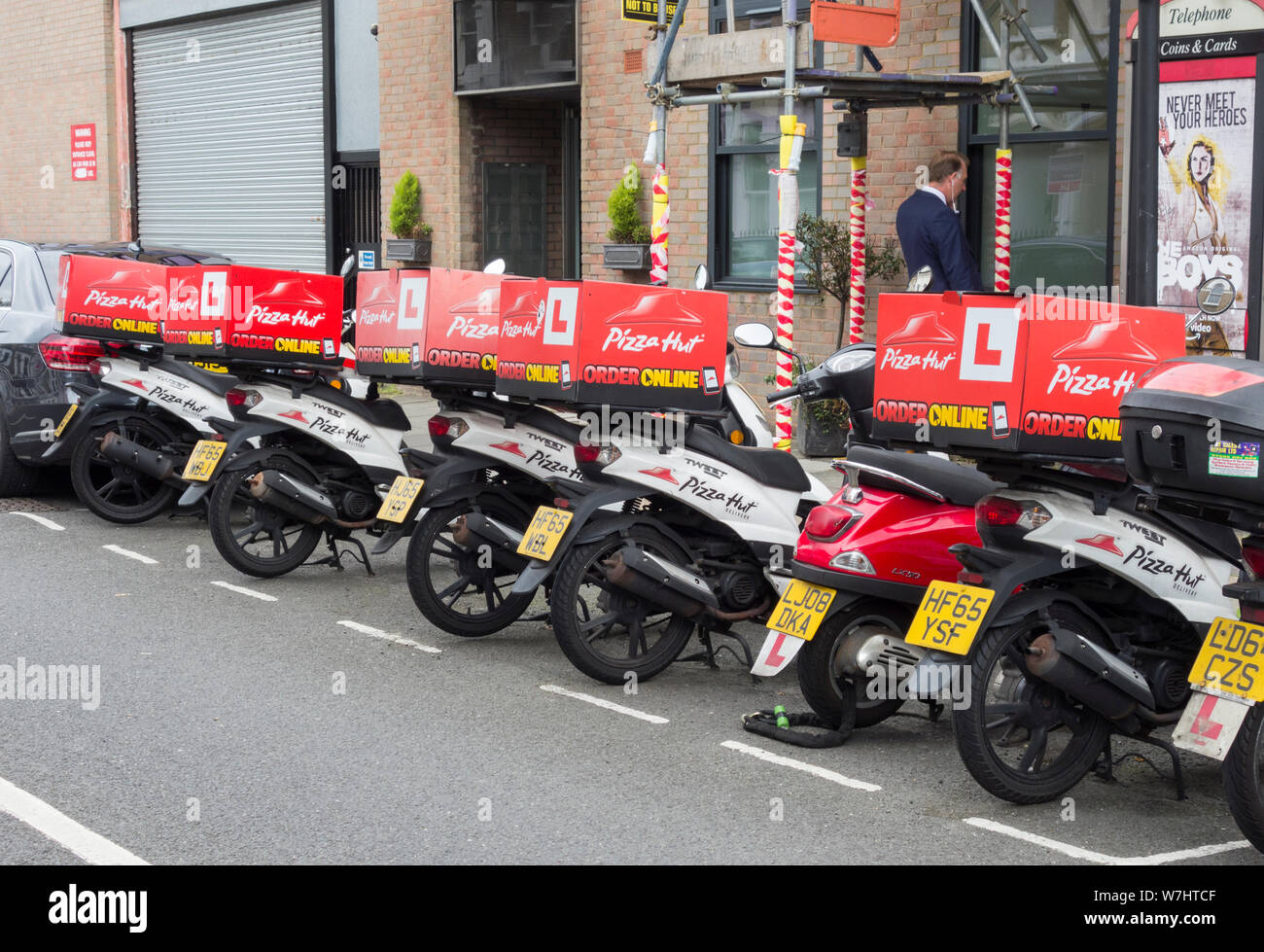 A row of PIzza Hut scooters parked outside one of its shops on Fulham Road, Fulham, London, UK Stock Photo