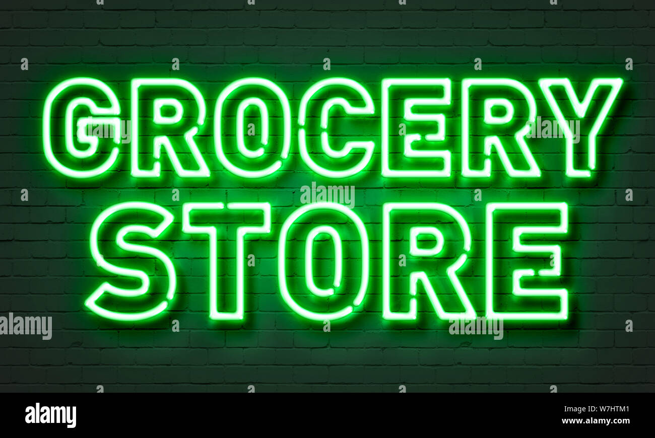 Grocery store neon sign on brick wall background Stock Photo Alamy