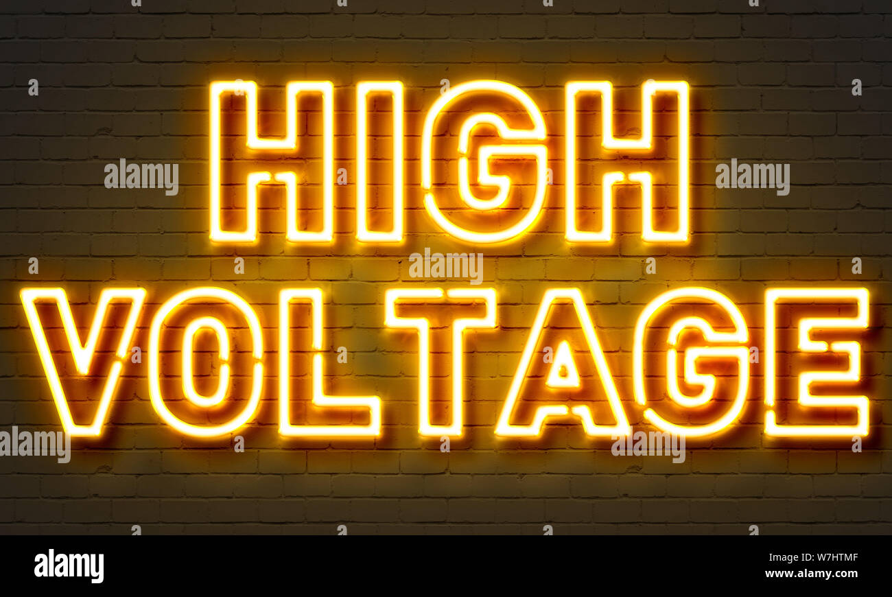 High voltage neon sign on brick wall background Stock Photo Alamy