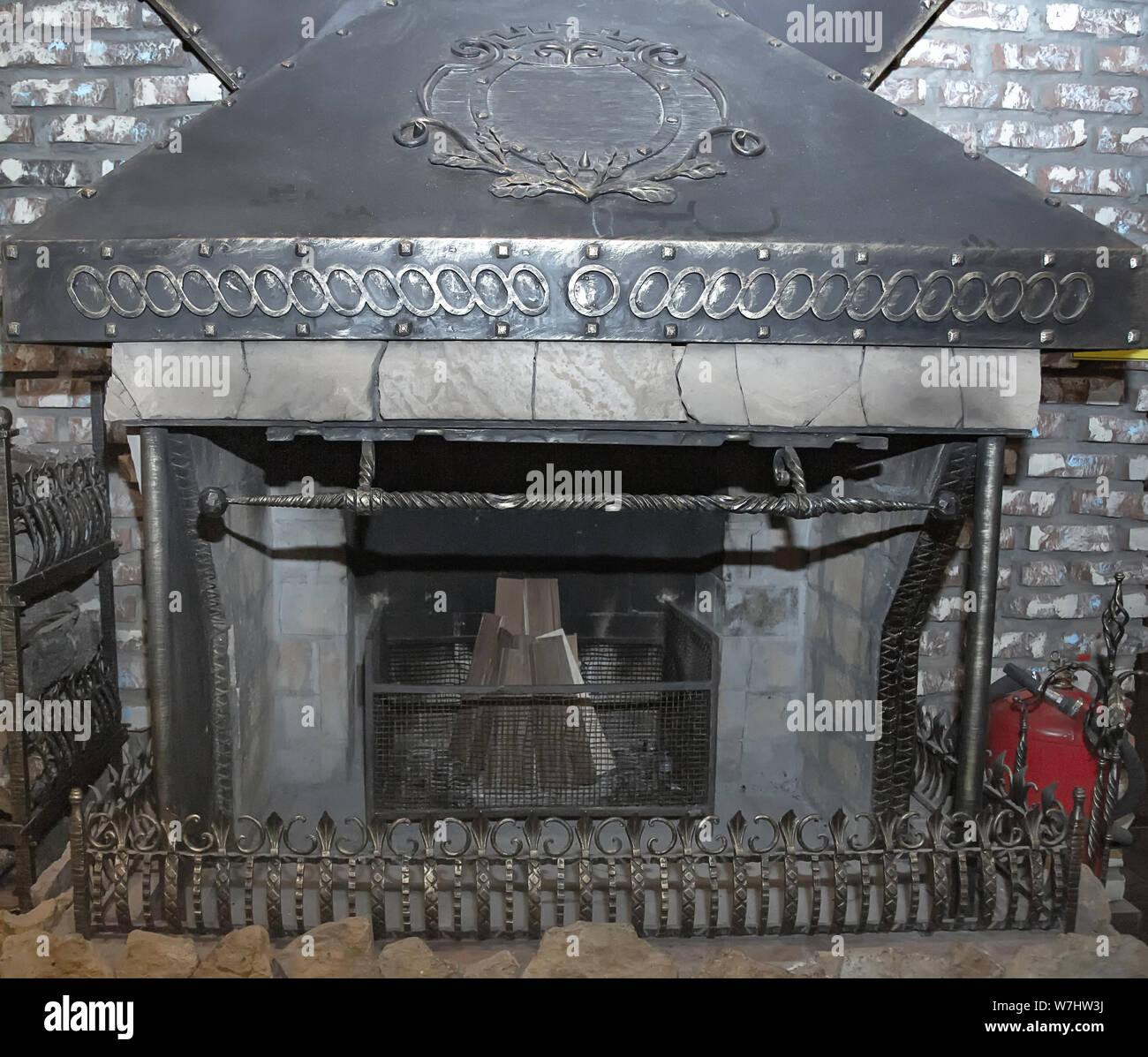 Photo background fireplace stove of iron welded gray welded decorated with metallic decor. Stock Photo