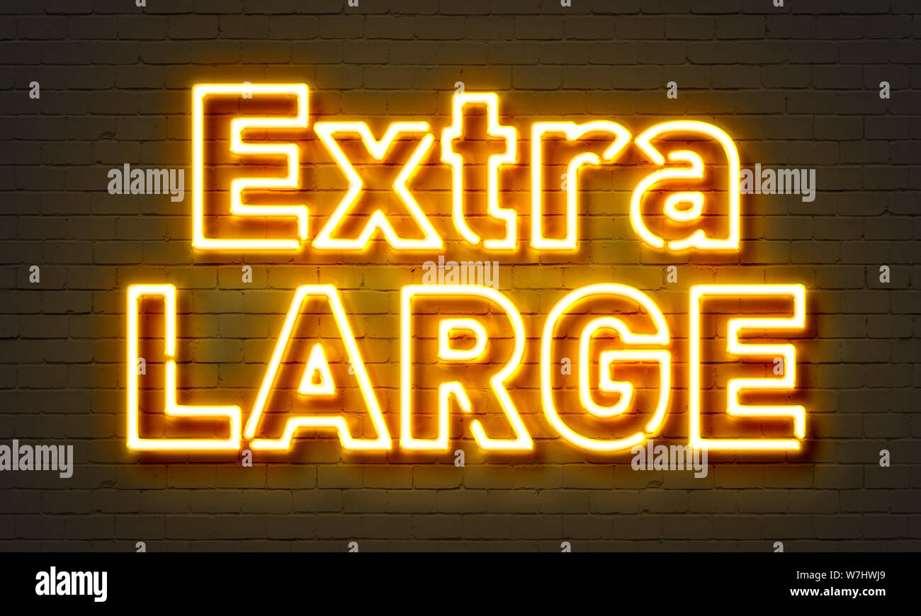 Extra large neon sign on brick wall background Stock Photo