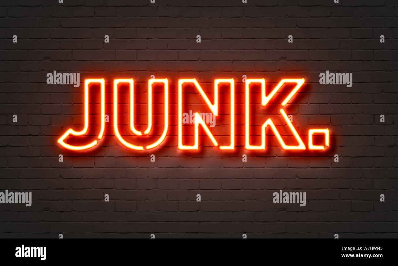 Junk neon sign on brick wall background Stock Photo