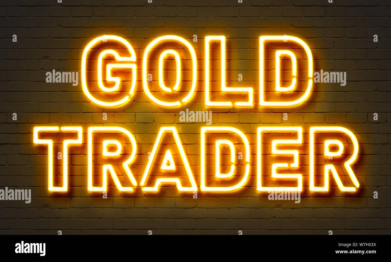 Gold trader neon sign on brick wall background Stock Photo