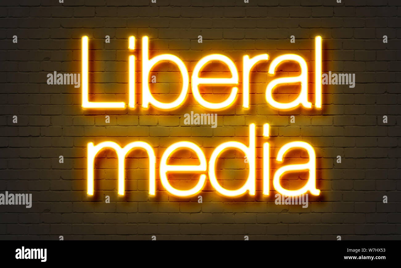 Liberal media neon sign on brick wall background Stock Photo