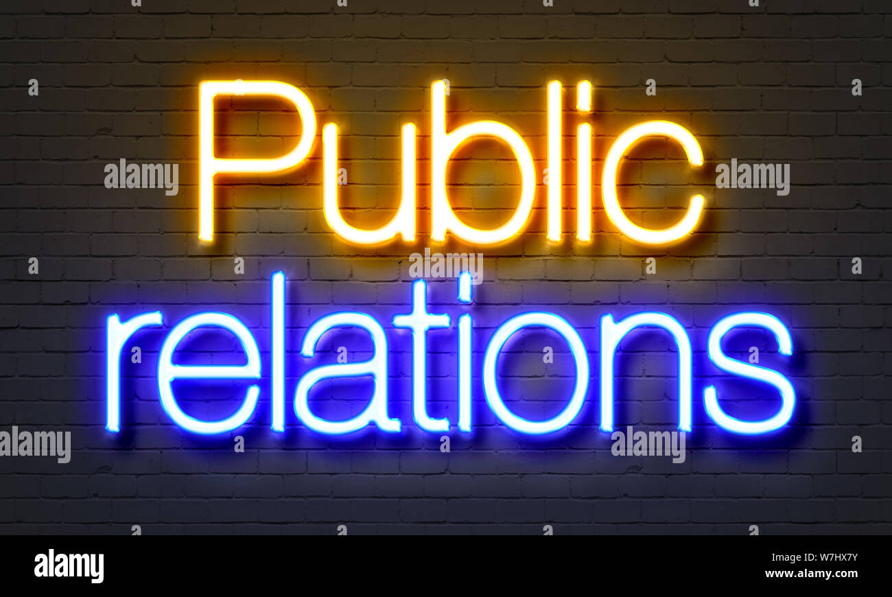Public relations neon sign on brick wall background Stock Photo