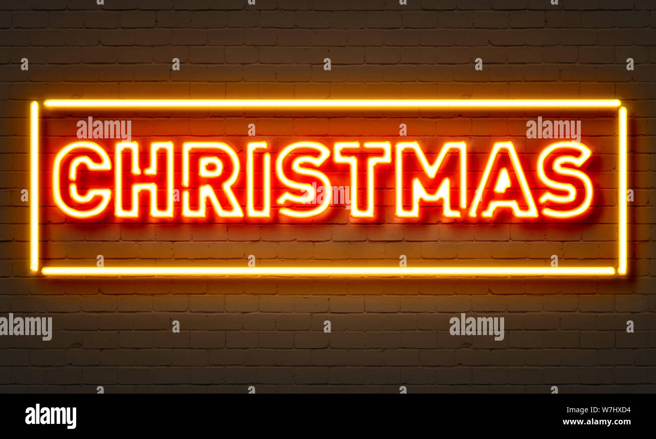 Christmas neon sign on brick wall background Stock Photo Alamy