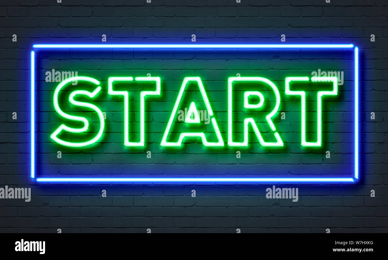 Start neon sign on brick wall background Stock Photo - Alamy