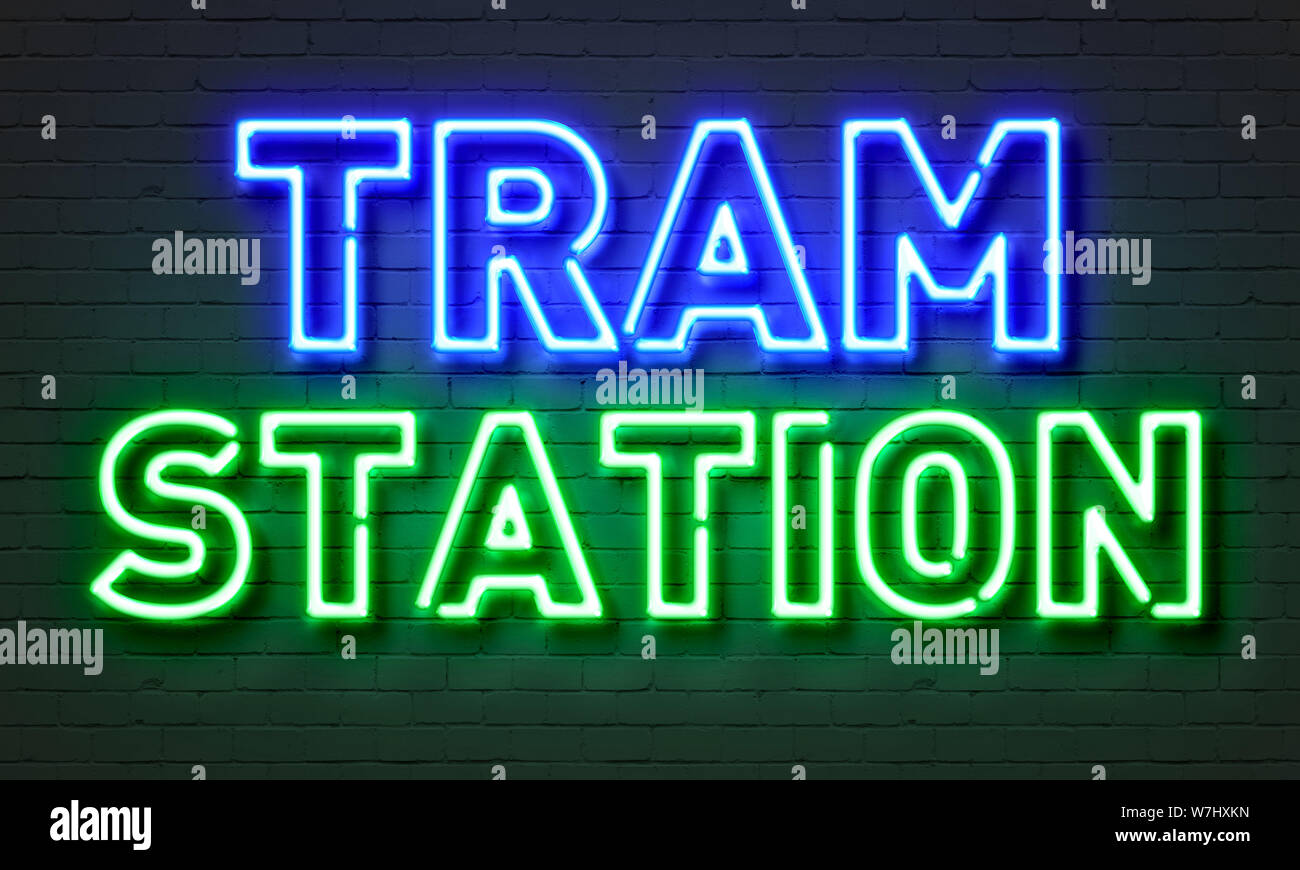 Tram station neon sign on brick wall background Stock Photo