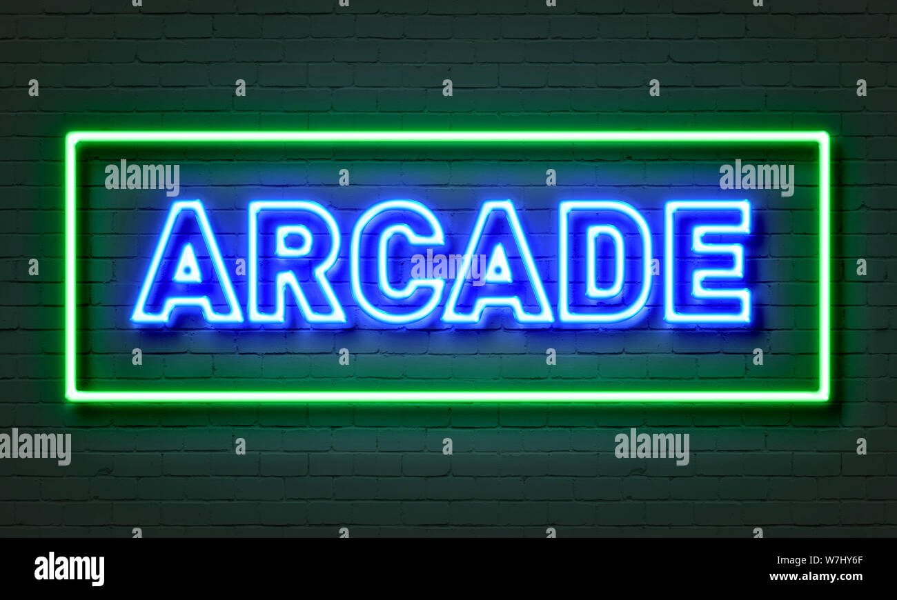 Arcade neon sign on brick wall background Stock Photo - Alamy