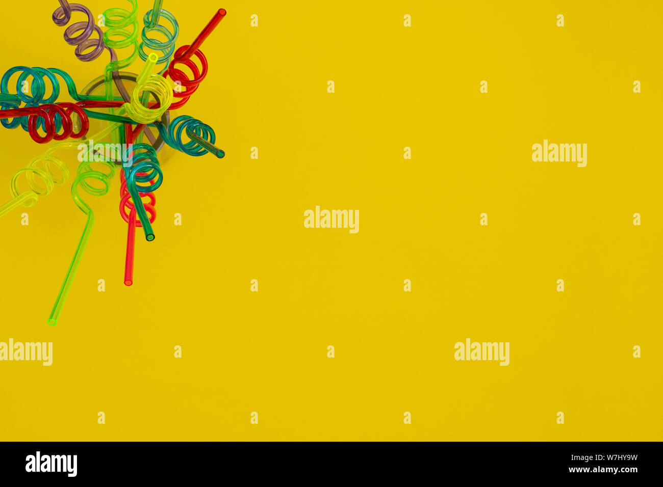 Spiral straws on a yellow background, top view Stock Photo