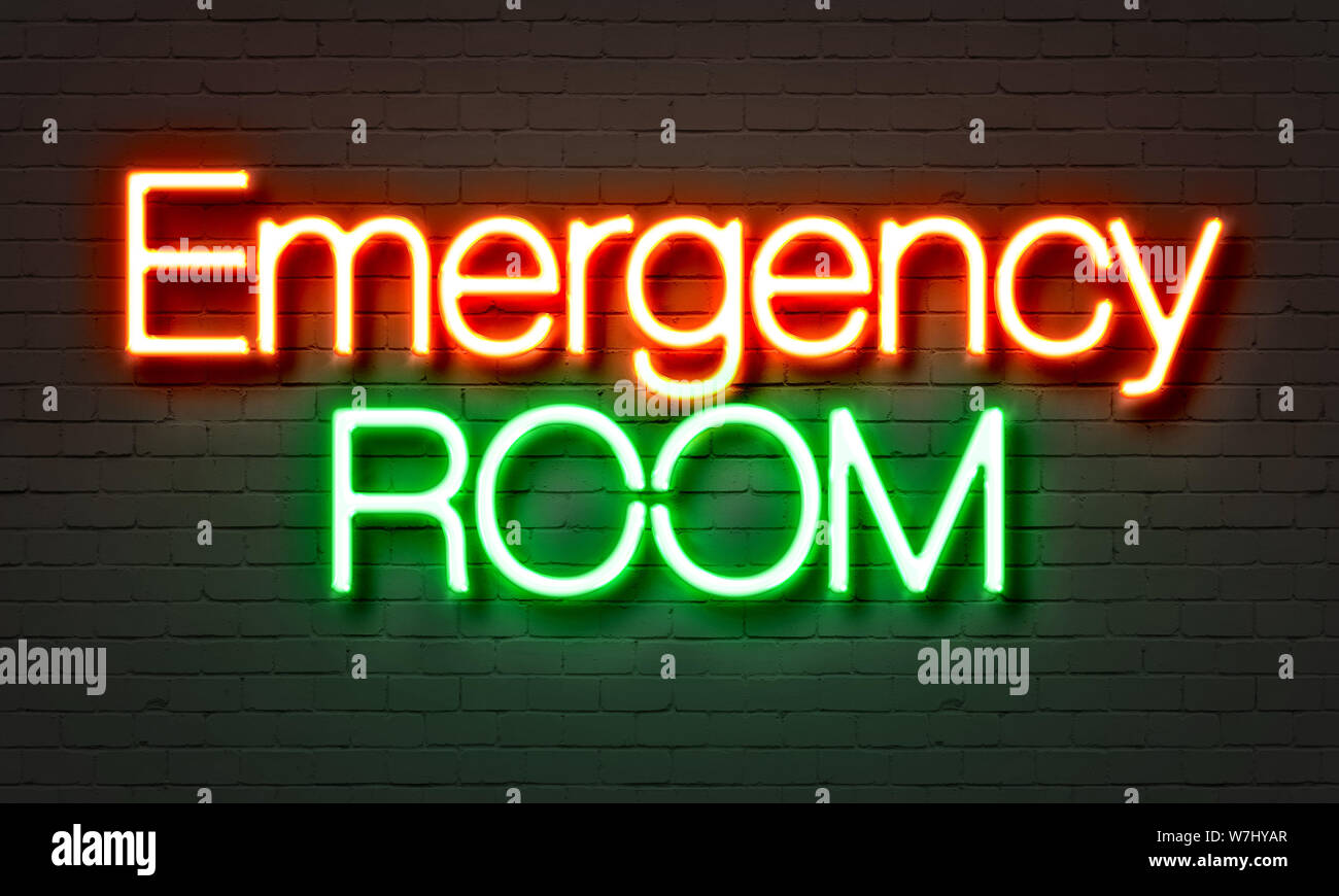 Emergency room neon sign on brick wall background Stock Photo