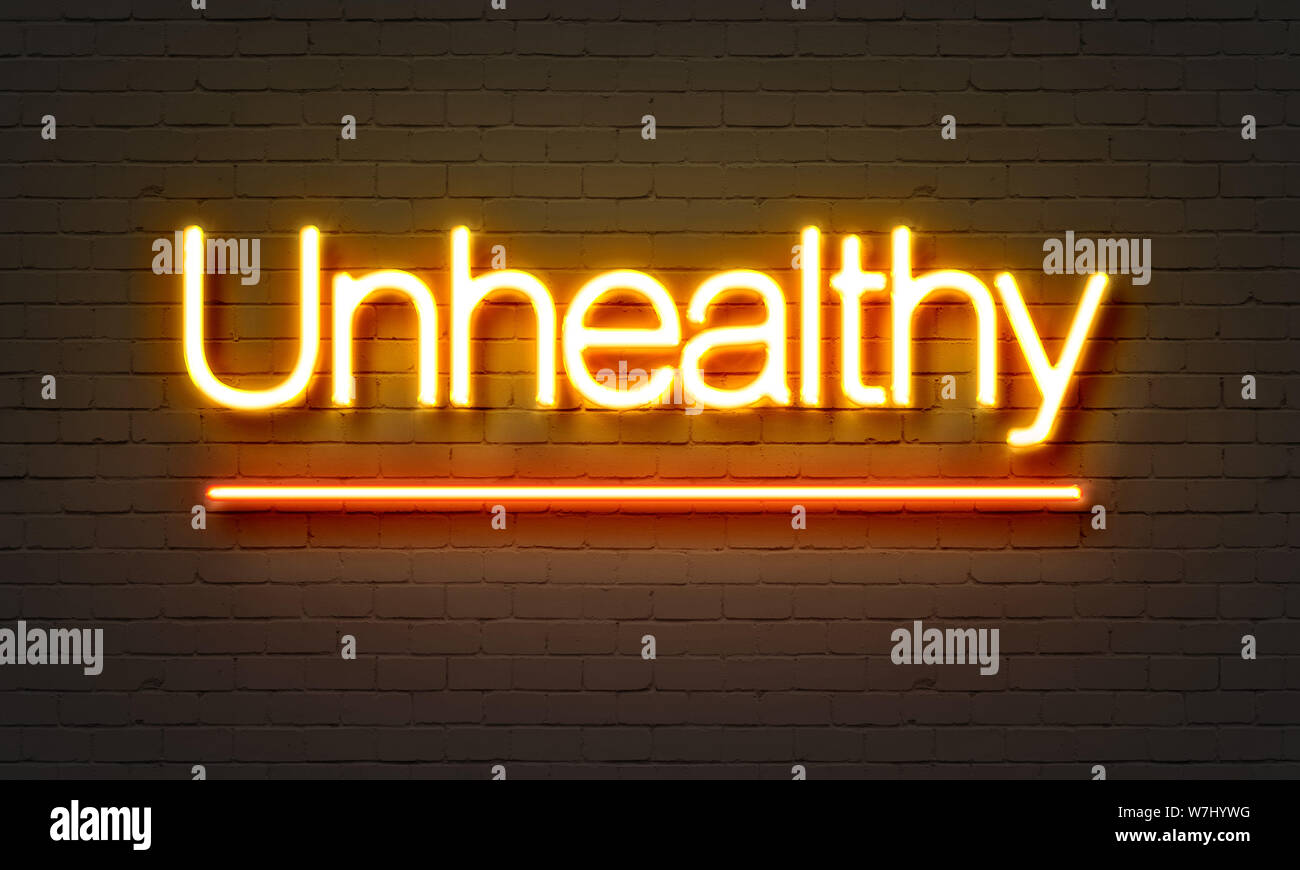 Unhealthy neon sign on brick wall background Stock Photo