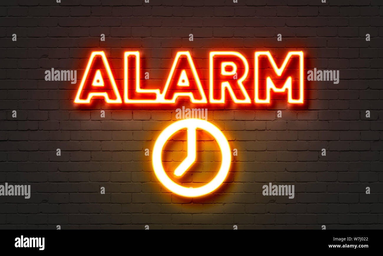 Alarm neon sign on brick wall background Stock Photo