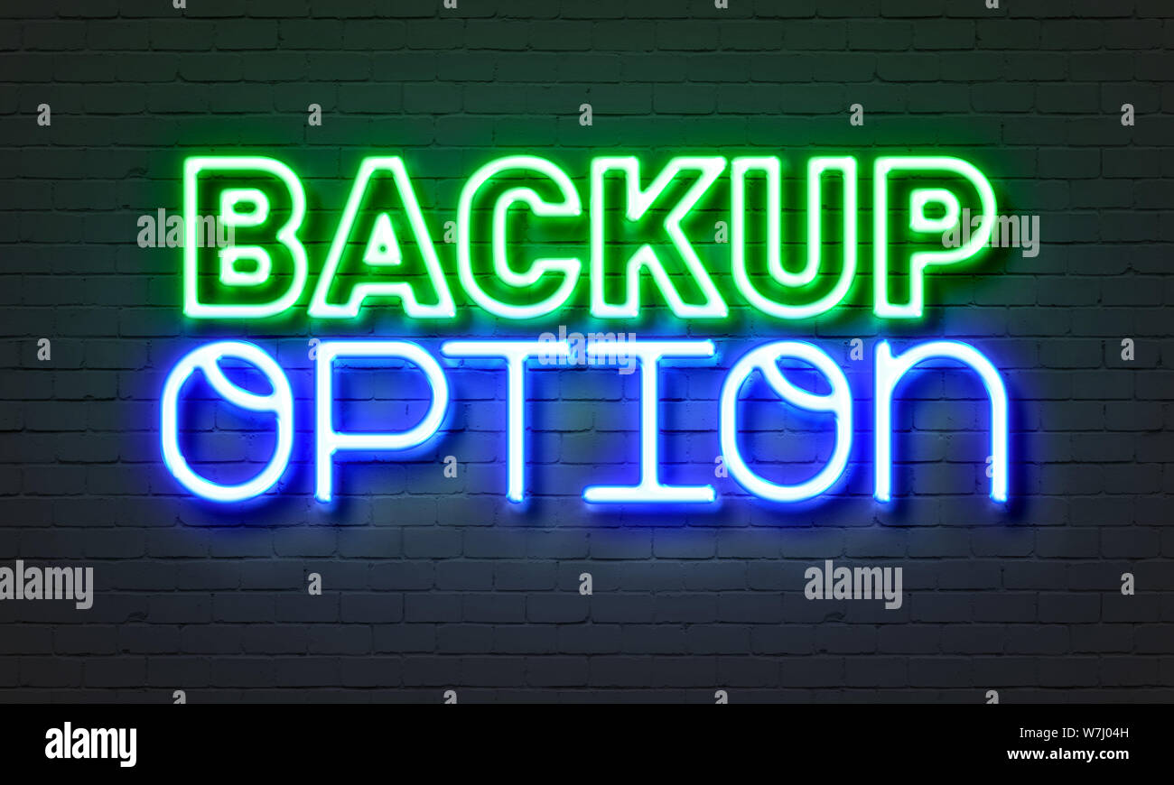 Backup option neon sign on brick wall background Stock Photo