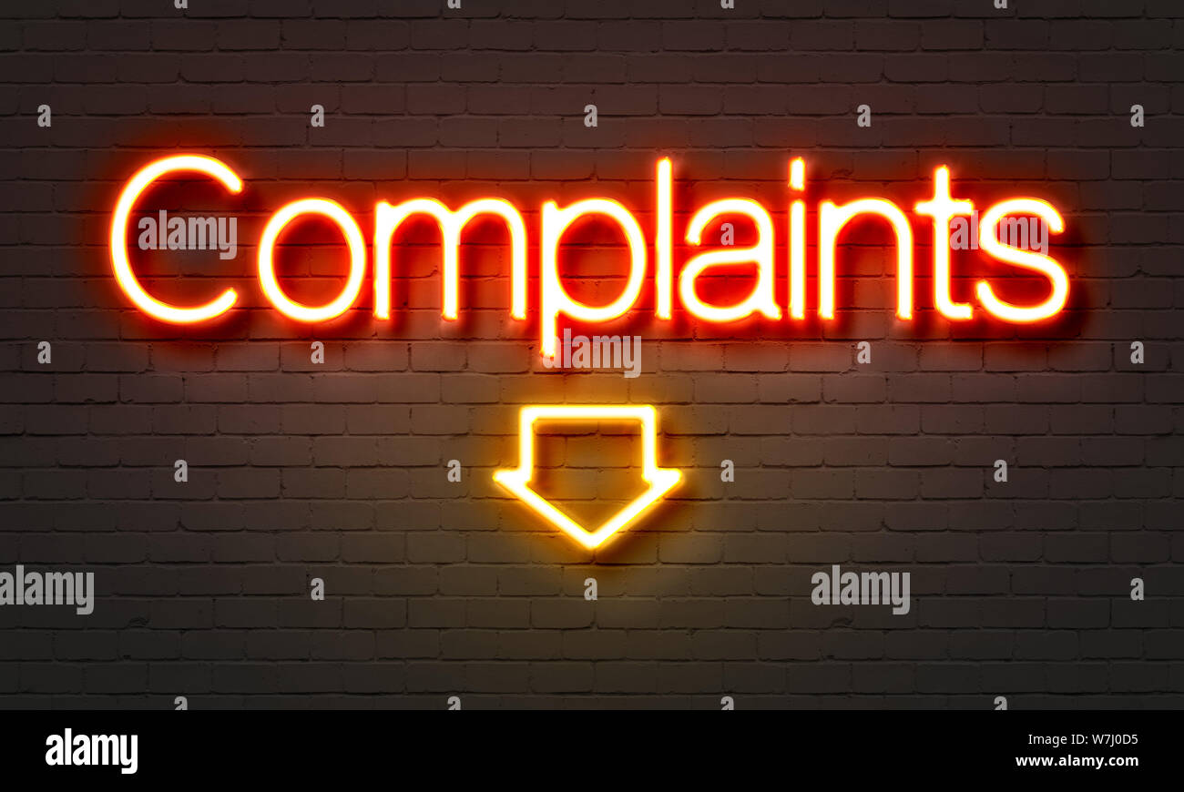 Complaints neon sign on brick wall background Stock Photo