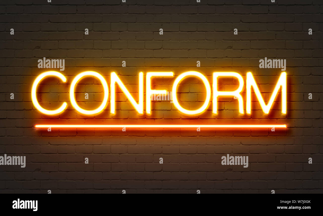 Conform neon sign on brick wall background Stock Photo