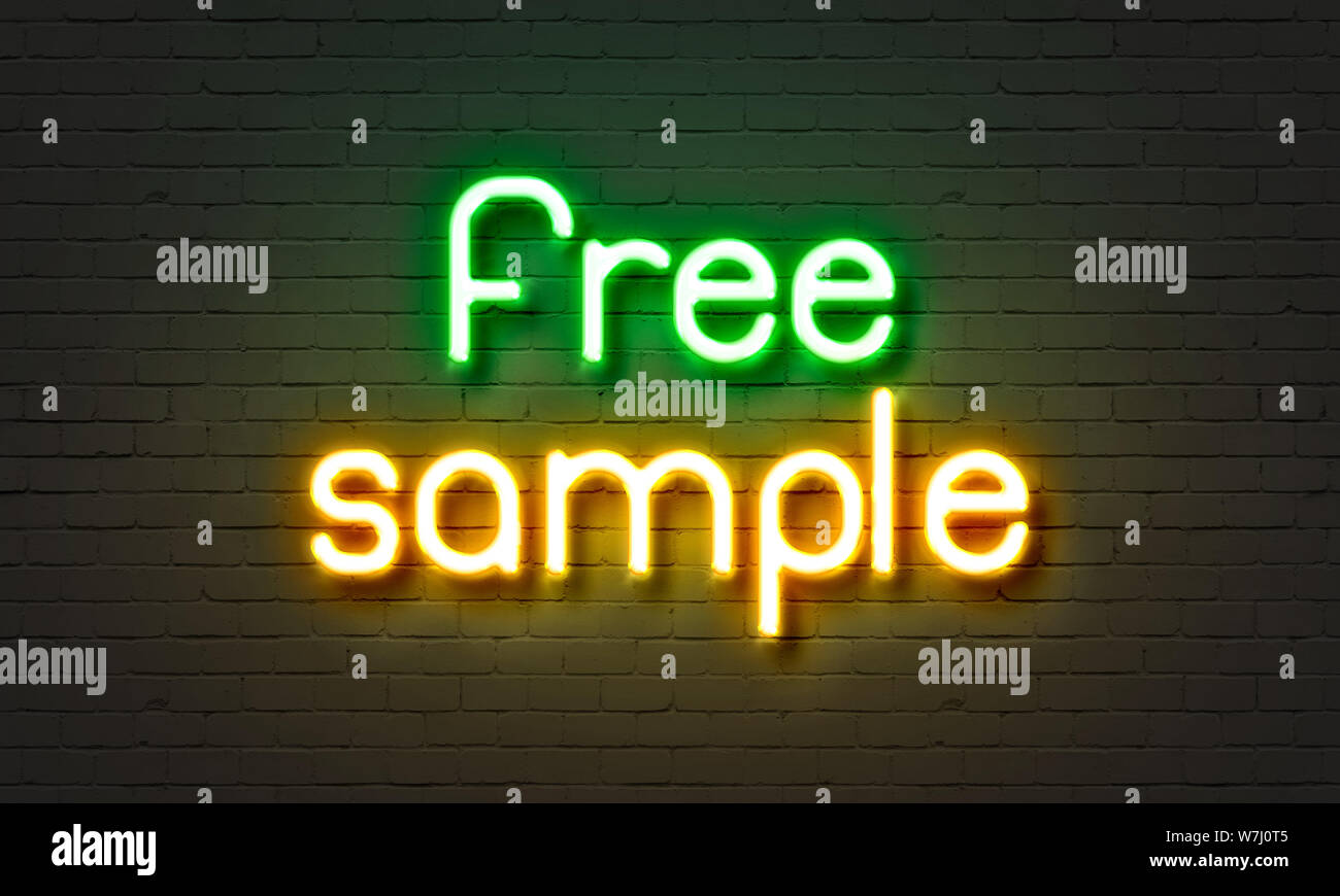 Free sample neon sign on brick wall background Stock Photo