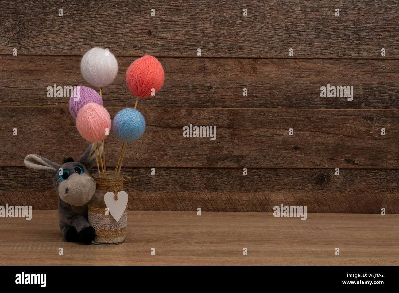 Pastel color wool balls and mason jar centerpiece Stock Photo Alamy