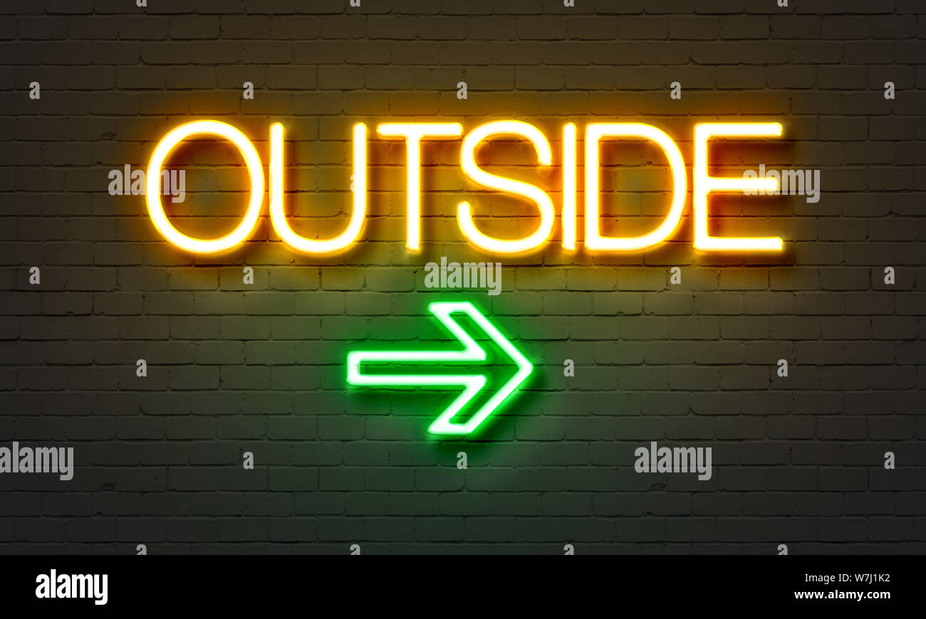 Outside neon sign on brick wall background Stock Photo