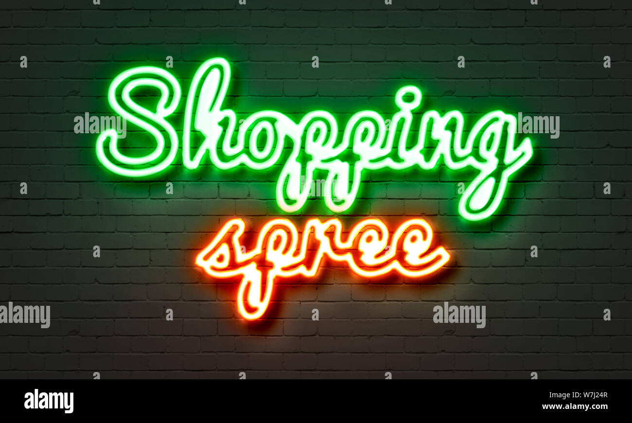 Shopping spree neon sign on brick wall background Stock Photo