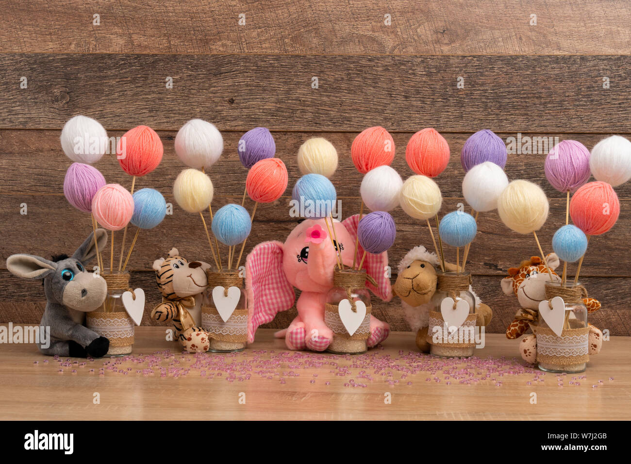 Baby toys and yarn balls for baptism centerpieces Stock Photo - Alamy