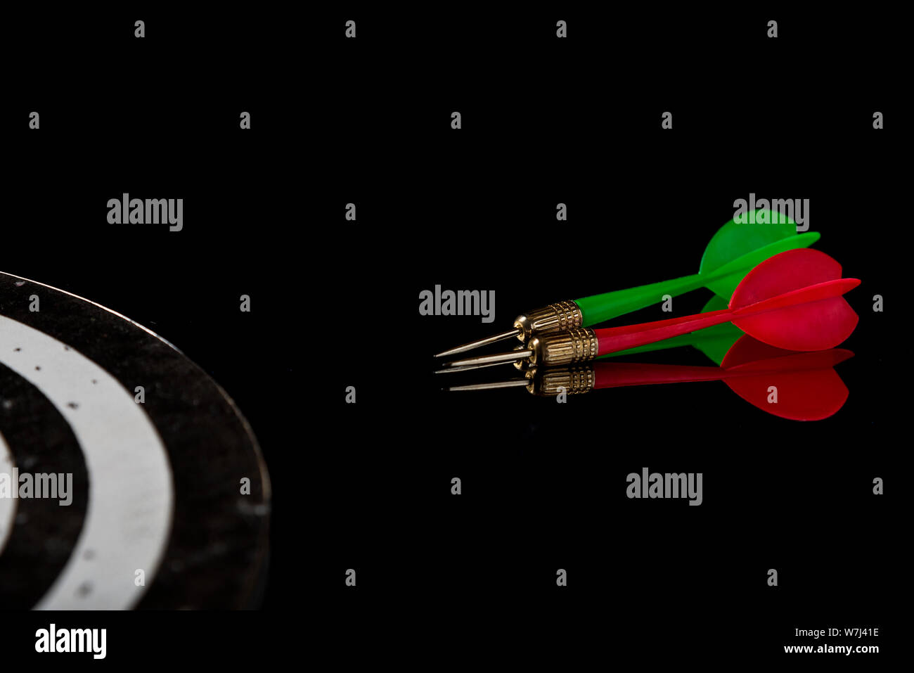Colored arrows on a black background and target. Hit the target. Stock Photo