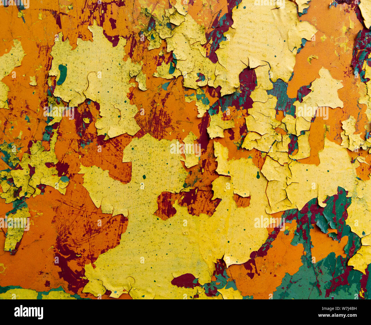 rusty metal sheet with peeling layers of paint of different colours - a surface texture photo Stock Photo