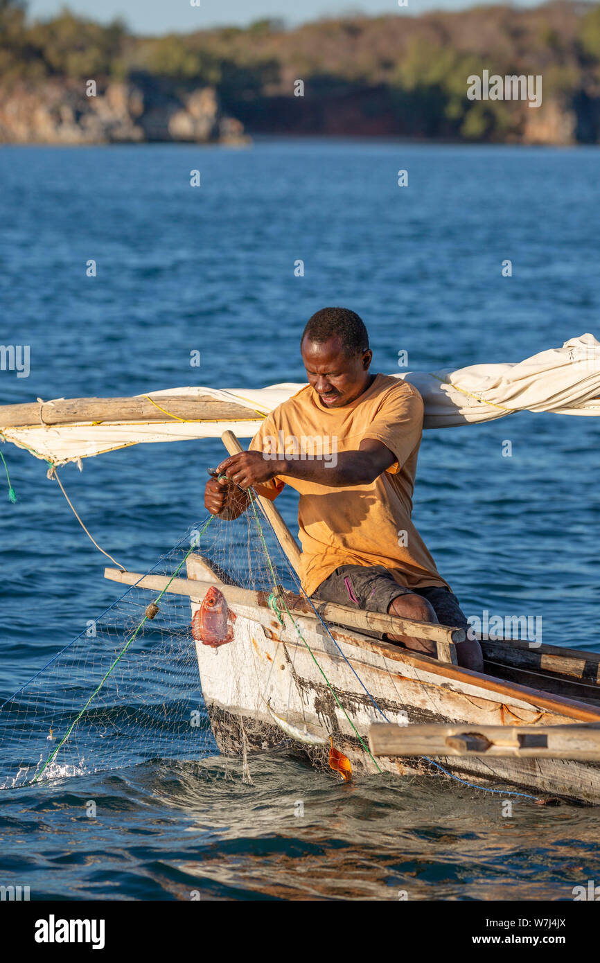 Africa, Madagascar, Anjajavy, local fishing boats and fisherman collecting their catch from the fishing net Stock Photo