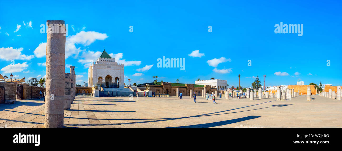 Panoramic landscape with ancient columns and view of Mausoleum Mohammed V in courtyard of incomplete Mosque. Rabat, Morocco, Africa Stock Photo