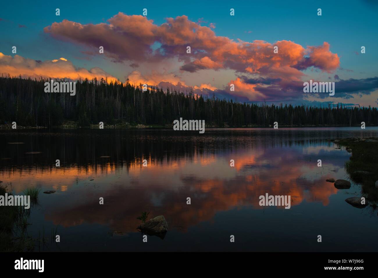 Clouds at sunset reflecting in a lake. Stock Photo