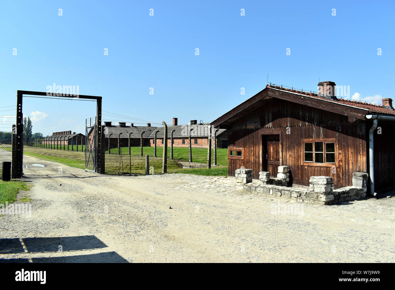 A main  entrance gate into the demolished accommodation with a timber building at the Birkenau Concentration Camp in Pol Stock Photo
