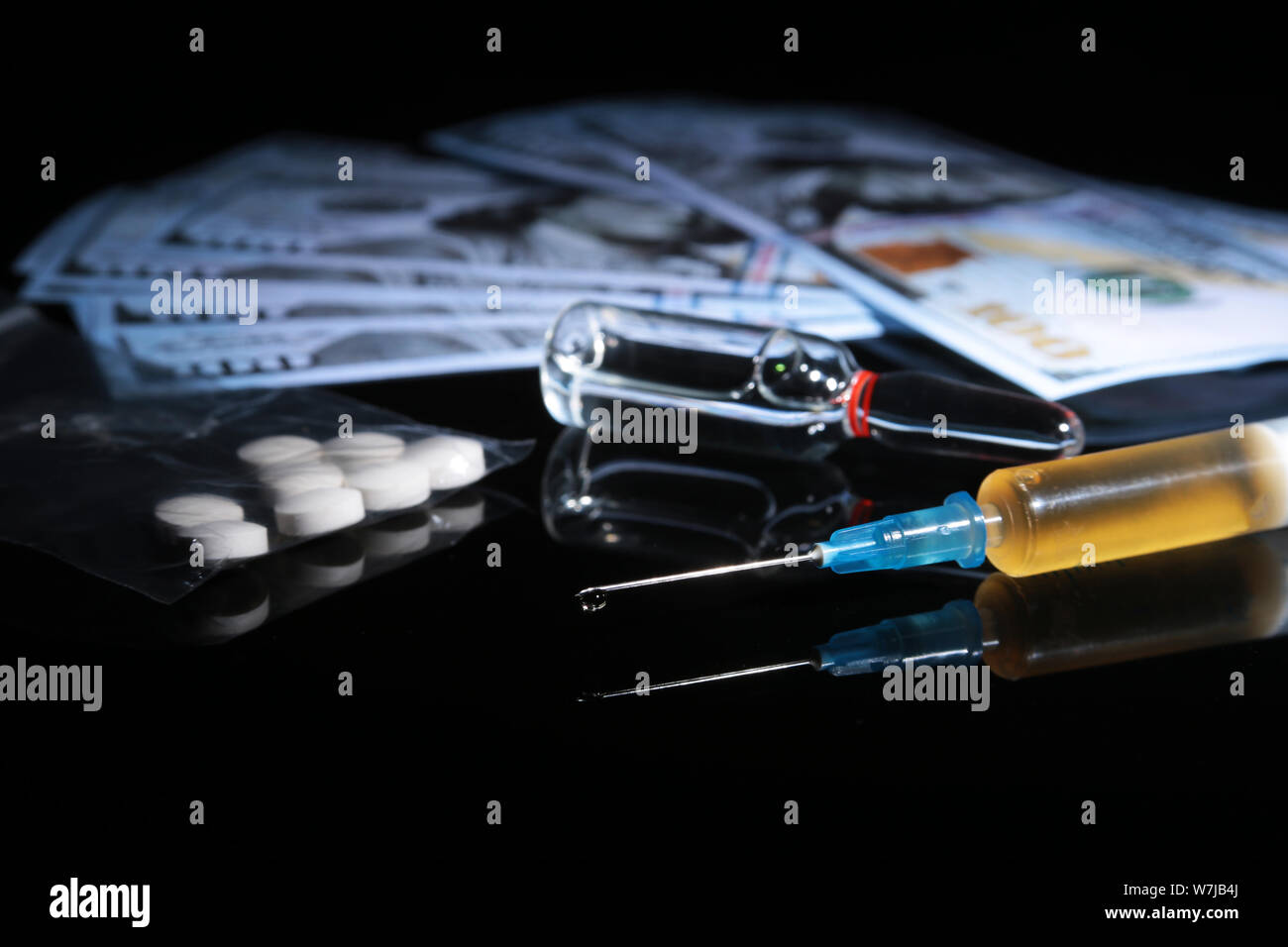 drug trafficking, crime, addiction and sale concept - closeup of with drugs and money. Stock Photo