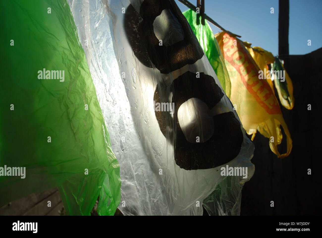 Plastic Carrier Bags hanging out to dry on a washing line, Mwandi