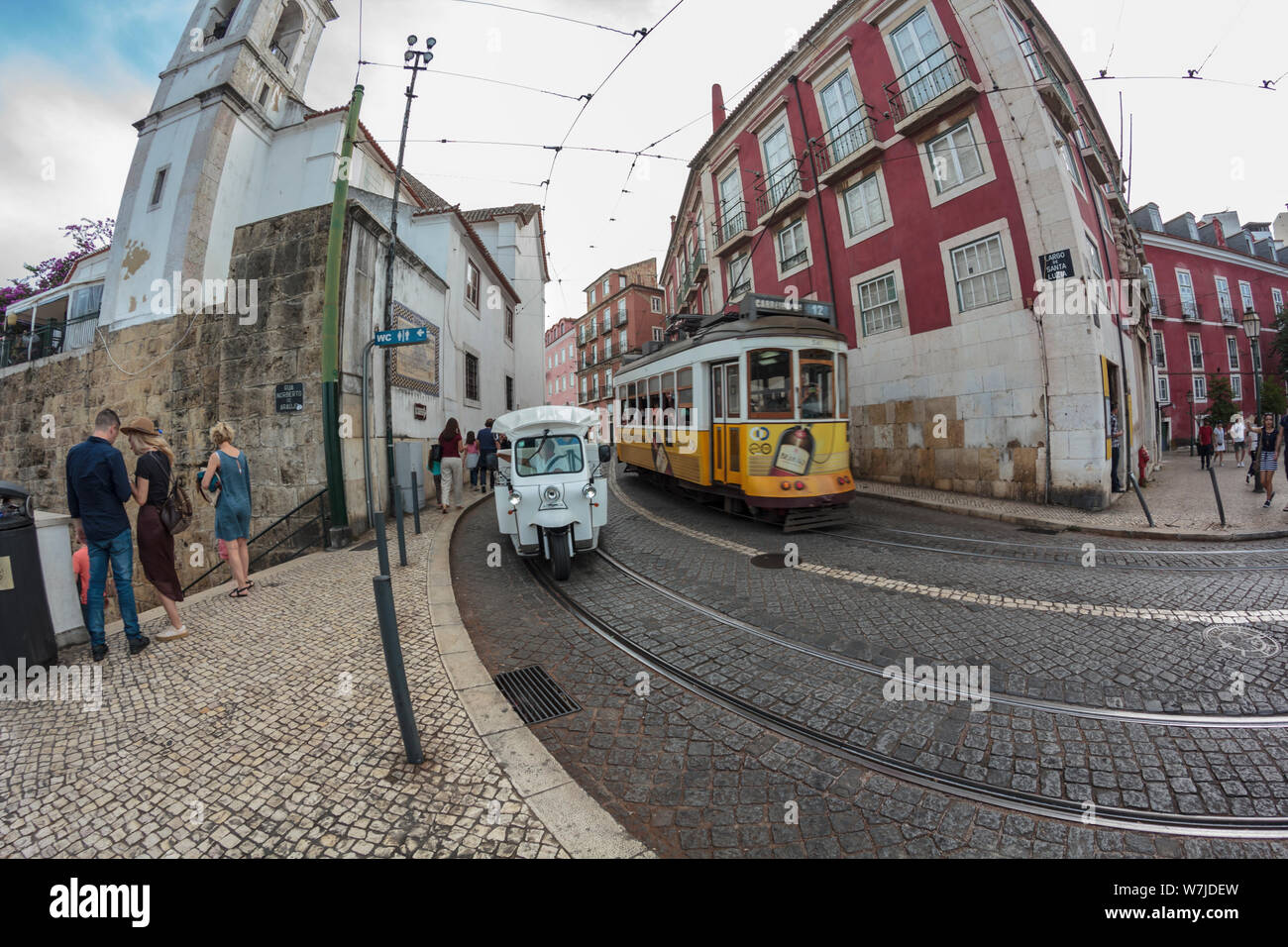 Lisbon, Portugal - CIRCA July,2019: Lisbon street with tuk tuk and typical yellow tram. Fish eye view Stock Photo
