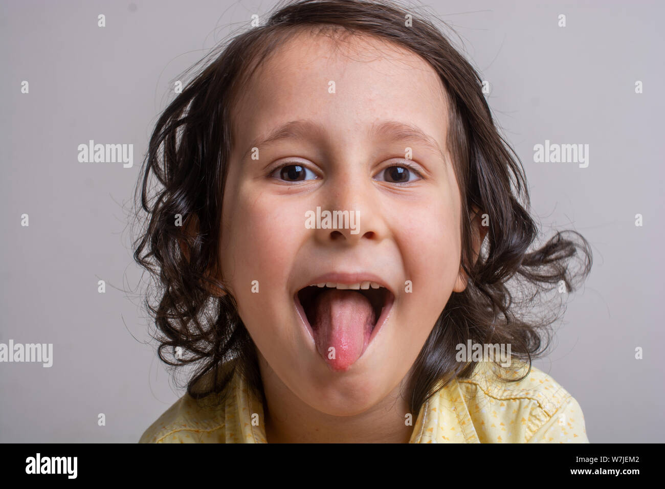 Closeup portrait of alittle boy sticking his tongue out Stock Photo