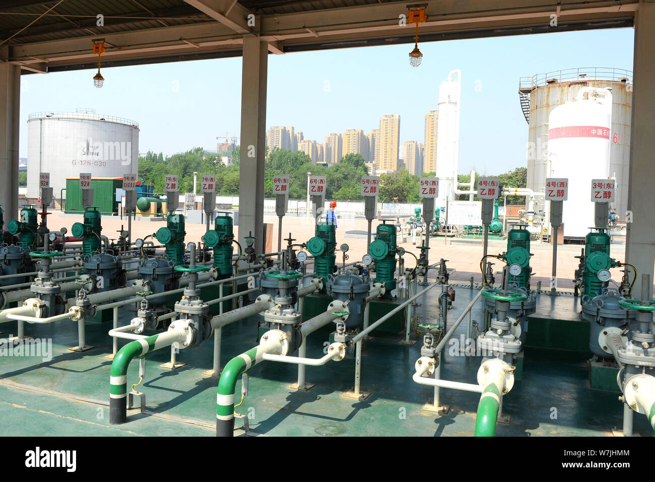 Chinese workers check fuel pipes of ethanol gasoline and other kinds of