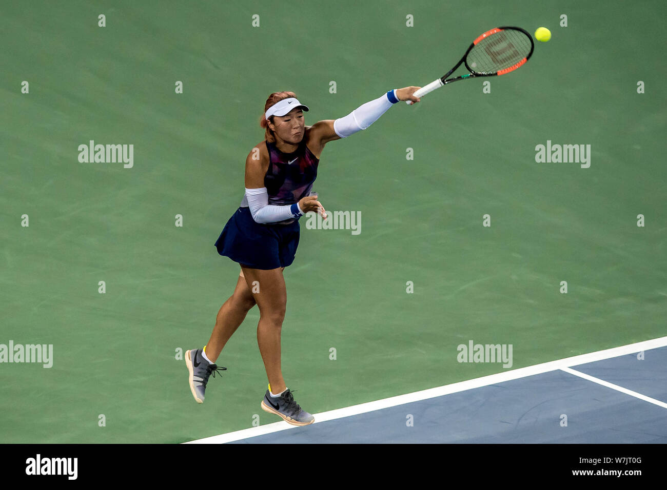 Han Xinyun of China returns a shot to Samantha Stosur of Australia in their first round match during the WTA Guangzhou International Women's Open 2017 Stock Photo