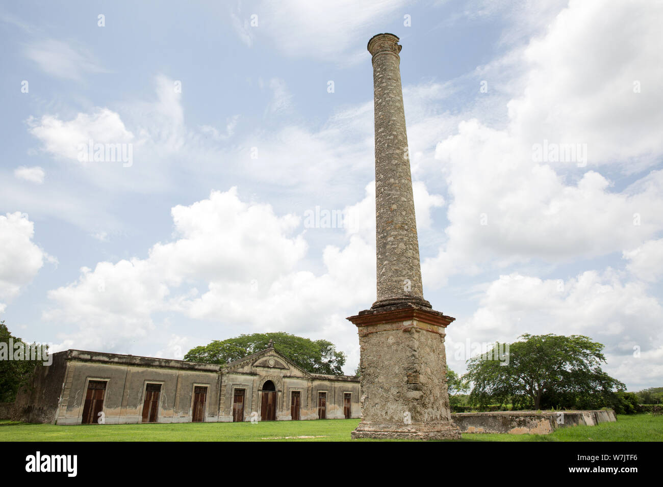 Chimney of the old henequen factory at Hacienda Yaxcopoil in the Uman Municipality, state of Yucatan, Mexico on July 22, 2019. Hacienda Yaxcopoil dates back to the 17th century and was once considered one of the most important rural estates in the Yucatan, spreading across 22,000 acres. It operated first as a cattle ranch and later as a henequen plantation during the golden age of the 'agave sisal'. Over time, due to continuous political, social and economic changes, the estate has been reduced to less than 3% of its original size. The production of henequen fiber in the hacienda ended in 1984 Stock Photo
