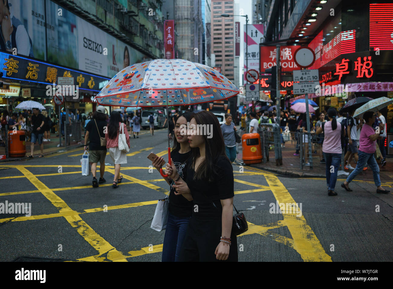 Women share an umbrella as they walk through the Mong Kok shopping district in Hong Kong, China, 28 August 2017.   Hong Kong is on the verge of seeing Stock Photo