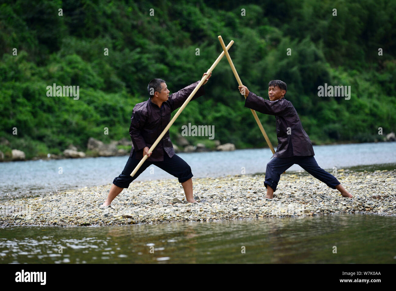 A Chinese villager of Miao ethnic group wearing traditional costumes  practises ''Miao stickfighting'', a unique martial art of the Miao Martial  Arts i Stock Photo - Alamy