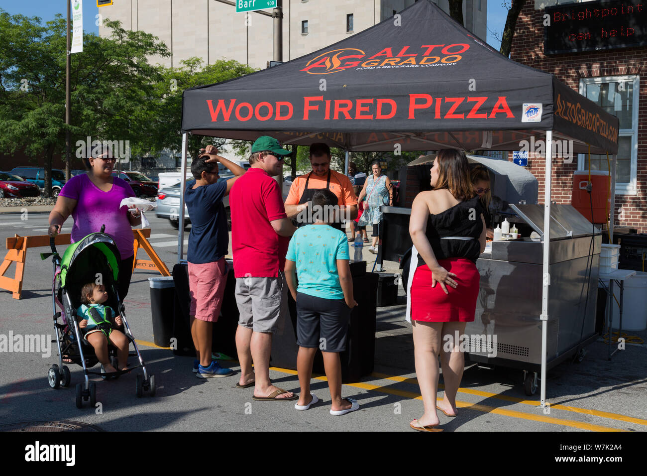 Customers gather around the Alto Grado Food and Beverage Company's tent at Fort Wayne's Farmers Market in downtown Fort Wayne, Indiana, USA. Stock Photo