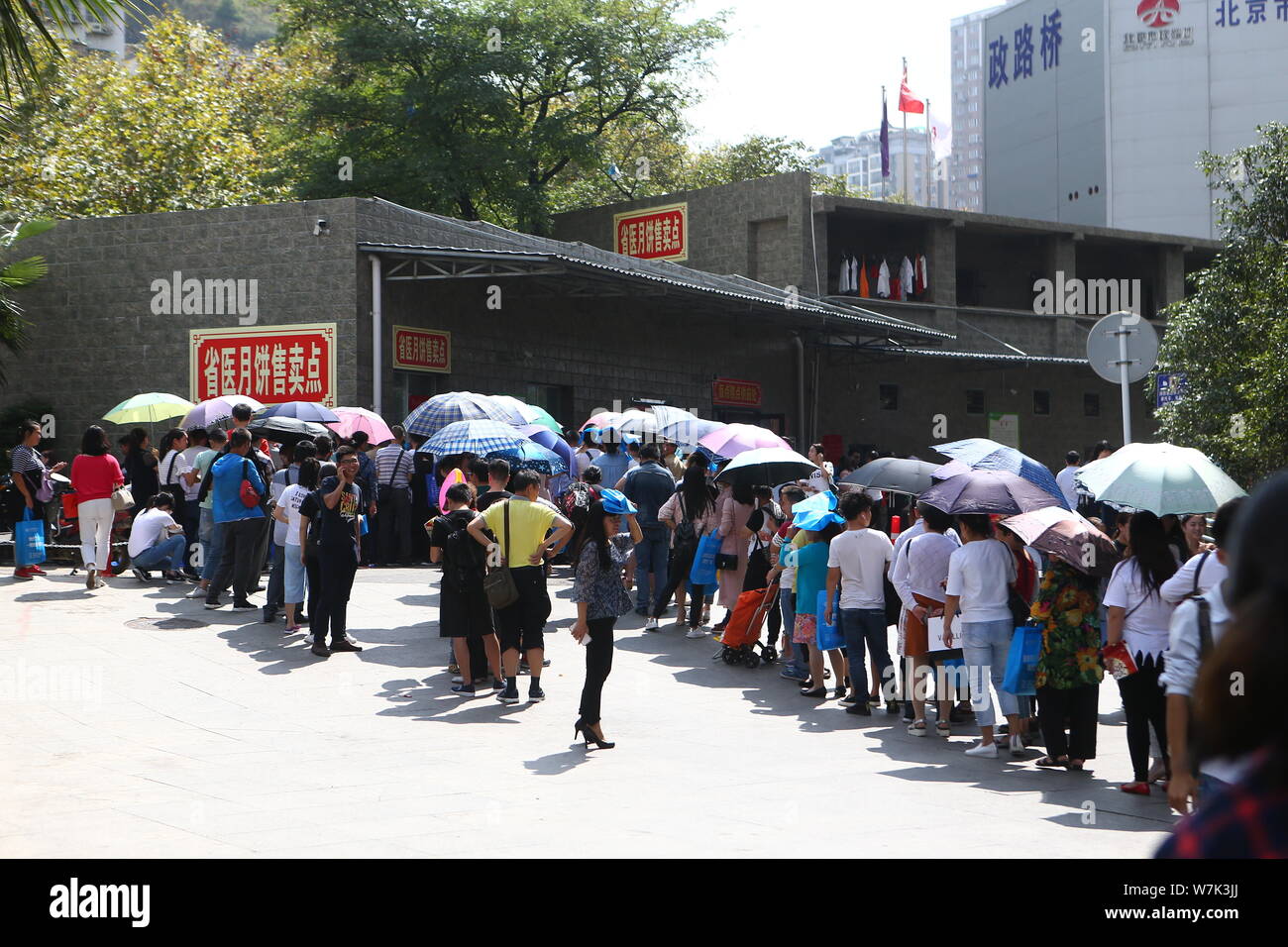 Chinese customers wait in long queue to buy mooncakes in front of a ...