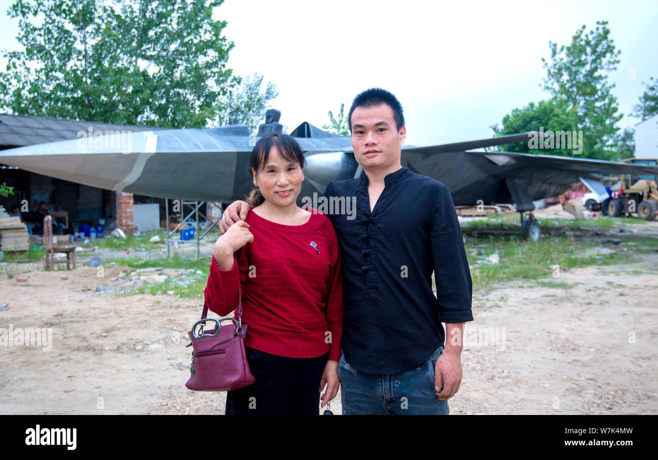 Chinese military enthusiasts Wan Li and his mother pose with the life-size model of the J-20 stealth fighter aircraft of Chinese PLA's (Peoples Libera Stock Photo